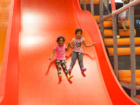 Cosmic Air Birthday Party Host serving pizza during a kids birthday party
